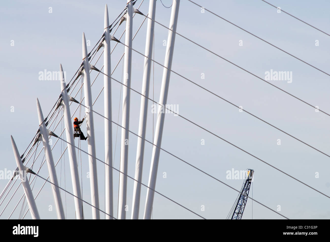 A workman painting the new footbridge at Salford Quays in Manchester, England Stock Photo