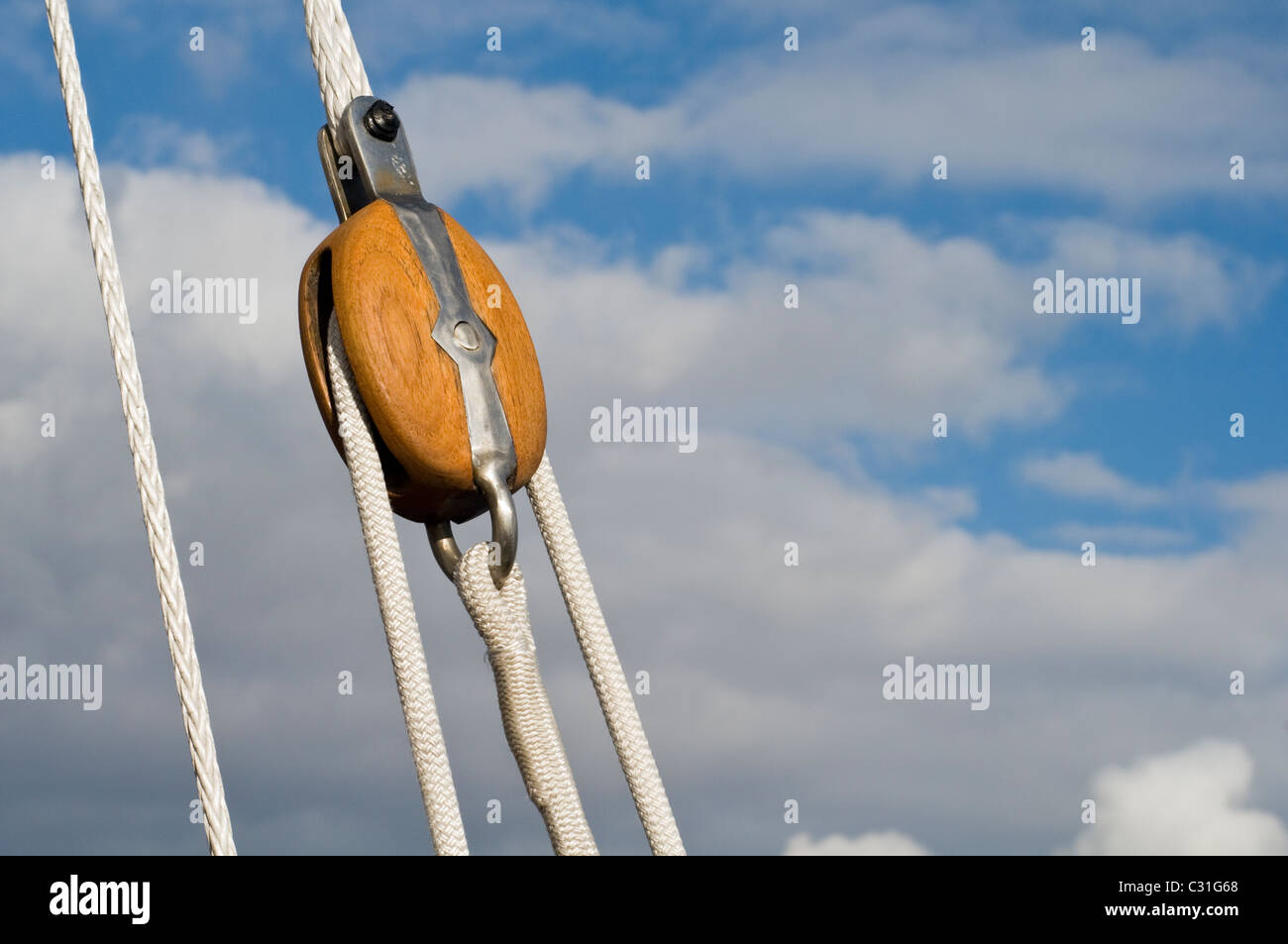 A wooden pulley and ropes on a sailing yacht Stock Photo