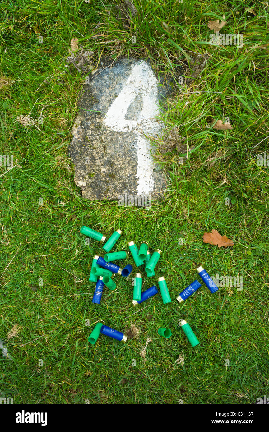 Spent cartridges from 12 bore shotgun (6-28 gm and 28gm 1 ounce) at shooting stand number 4 Stock Photo