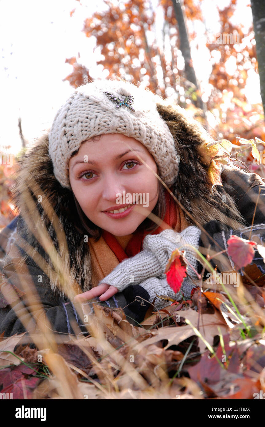 NATURAL BEAUTY. A YOUNG WOMAN LYING IN THE AUTUMN LEAVES Stock Photo ...