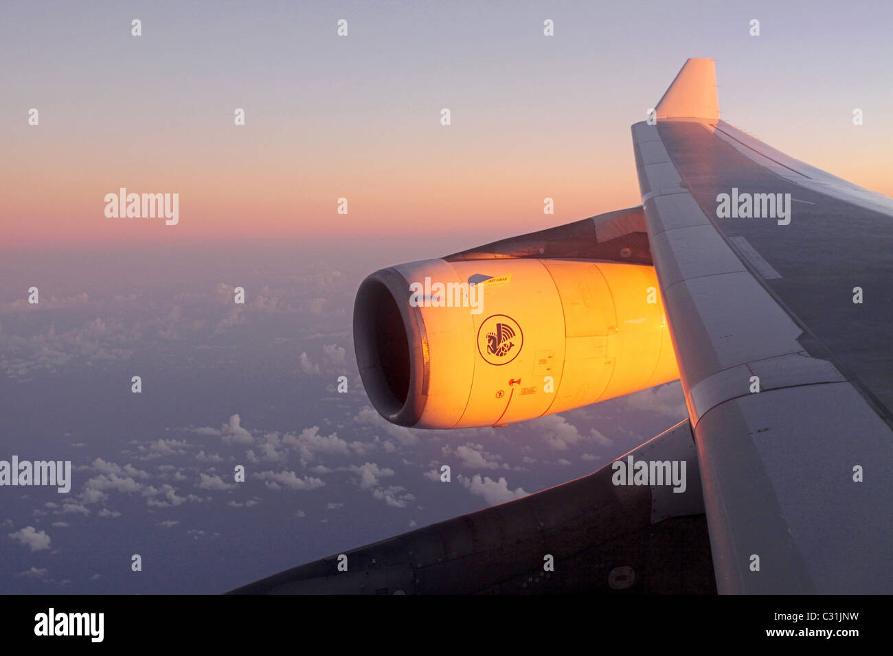 SUNSET OVER THE WING AND ENGINE OF AN AIR FRANCE AIRBUS A340 DURING A FLIGHT FROM SAINT MARTIN TO PARIS Stock Photo