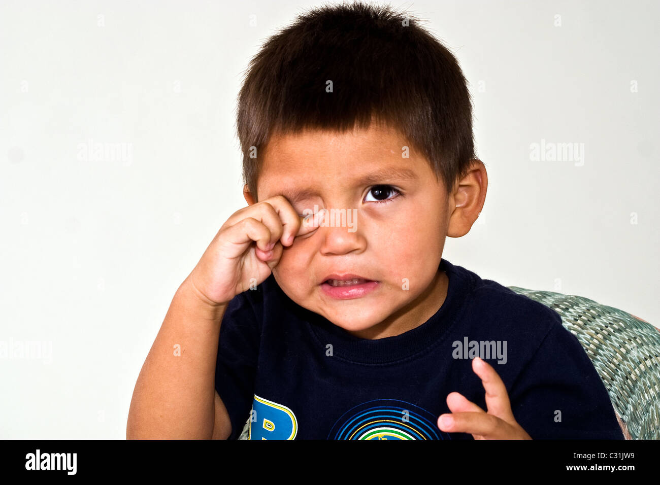 4-5 year old Hispanic boy portrait finger in eye contact  MR © Myrleen Pearson Stock Photo
