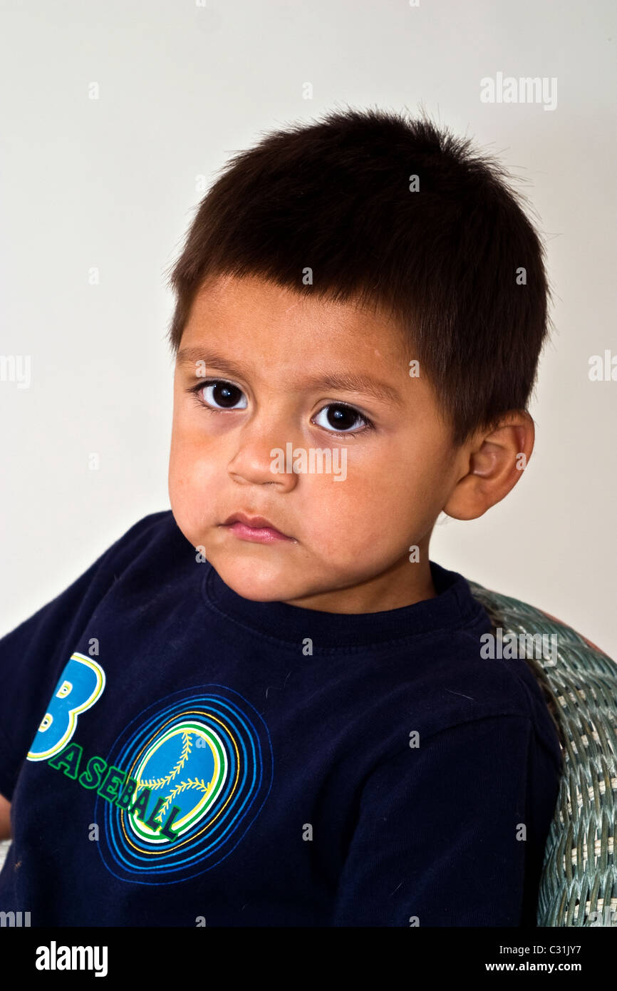 Boy sitting Alone sad 4-5 year years old Hispanic boy portrait eye contact MR © Myrleen Pearson Stock Photo