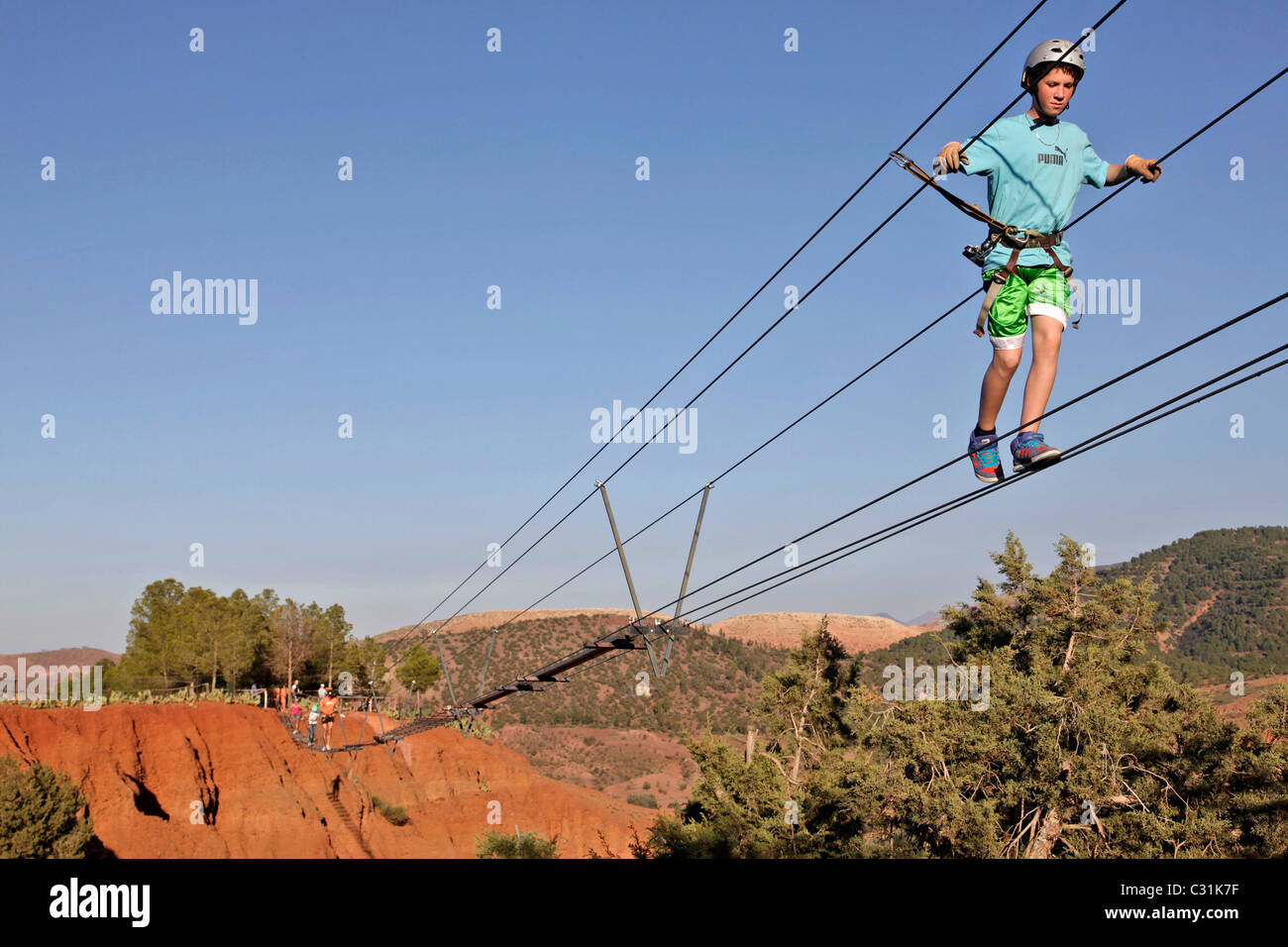 MONKEY BRIDGE HANGING BETWEEN THE RED EARTH CLIFFS, AERIAL PARK AT THE