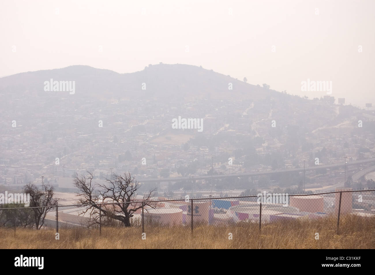 Hill full of houses and surrounded by very polluted air in central Mexico Stock Photo