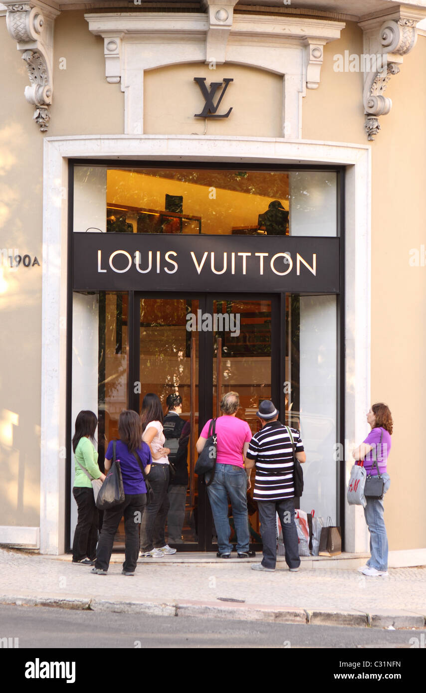 Louis Vuitton Lisbon Portugal shoppers wait outside the fashion shop on