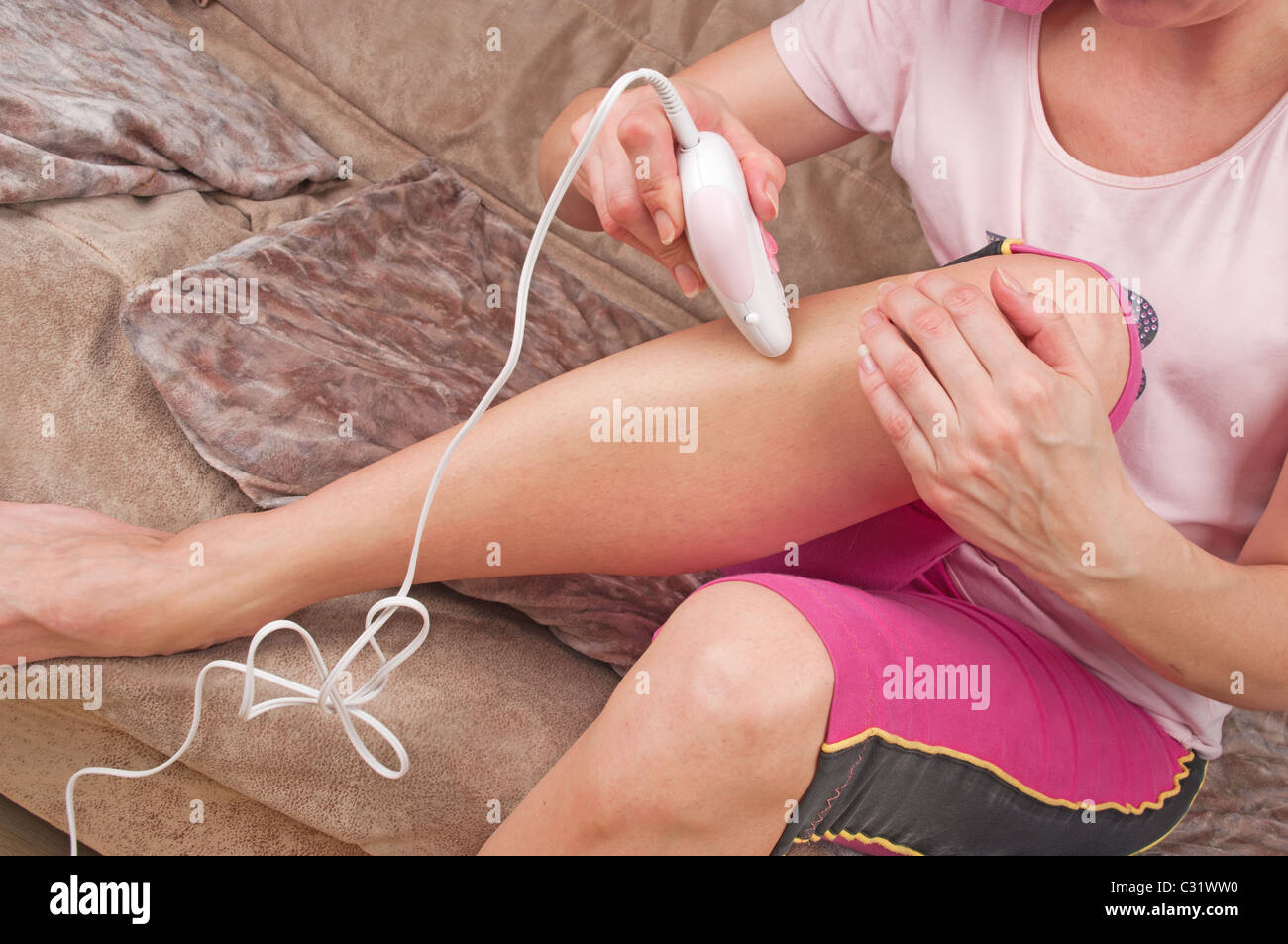 Epilation process in a Houses on sofa Stock Photo