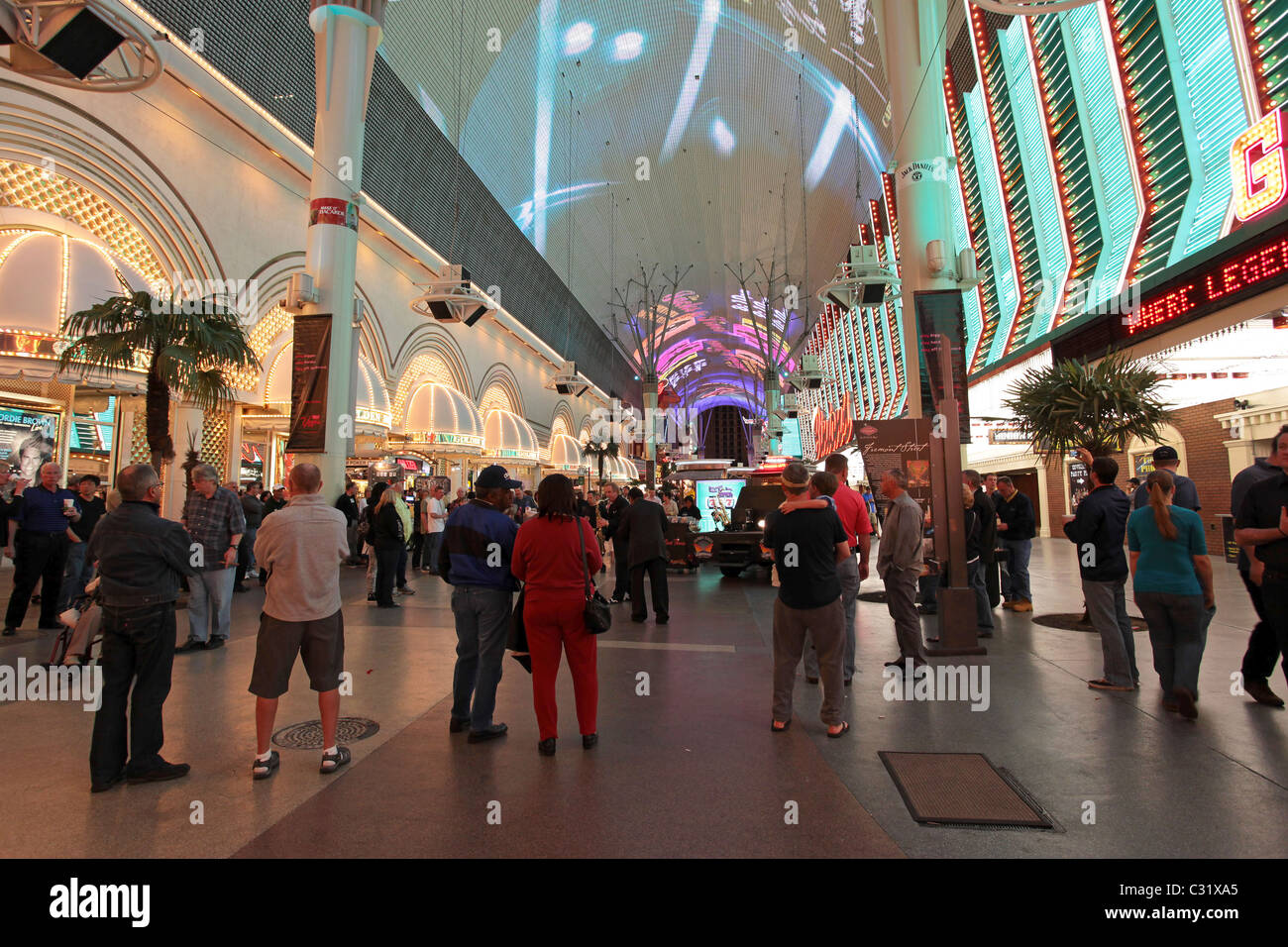 Las Vegas Fremont Street downtown with crowds of people and tourists standing in a road late at night. Stock Photo