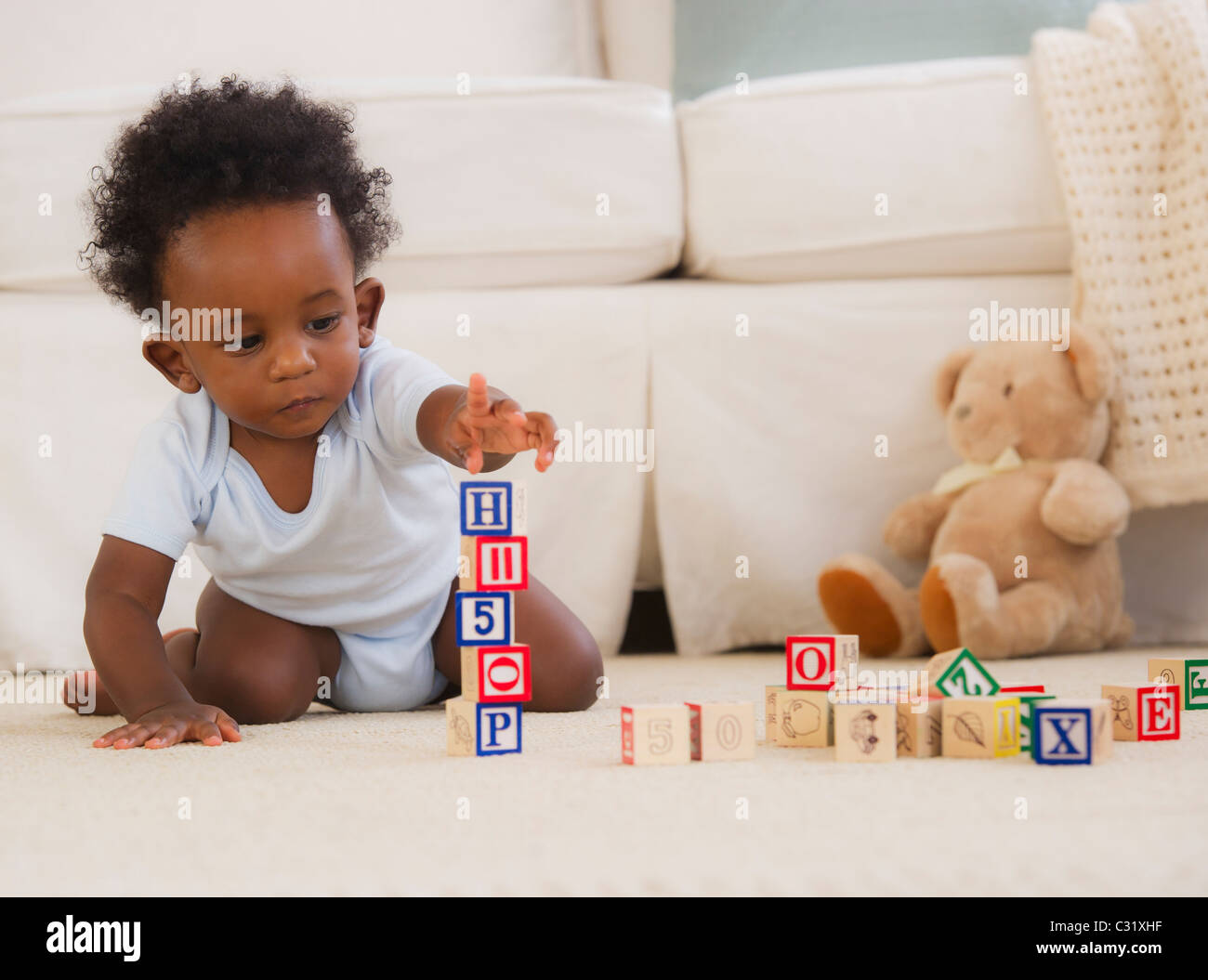 African baby playing with color blocks hi-res stock photography and