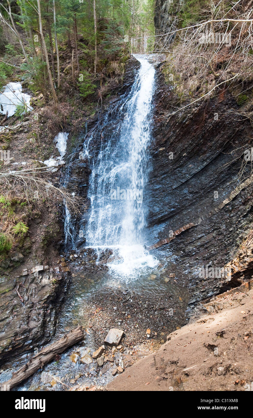 High mountain waterfall in wild Carpathian forest (Guk Waterfall, Ivano-Frankivsk Region, Ukraine). Stock Photo