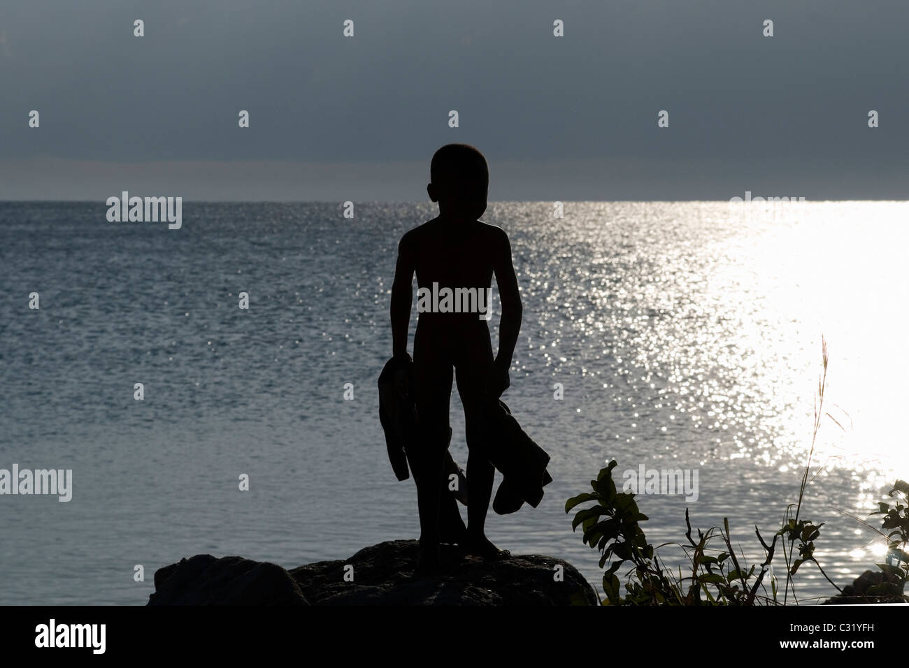 Young boy at sunrise Nkhata Bay, Malawi Stock Photo