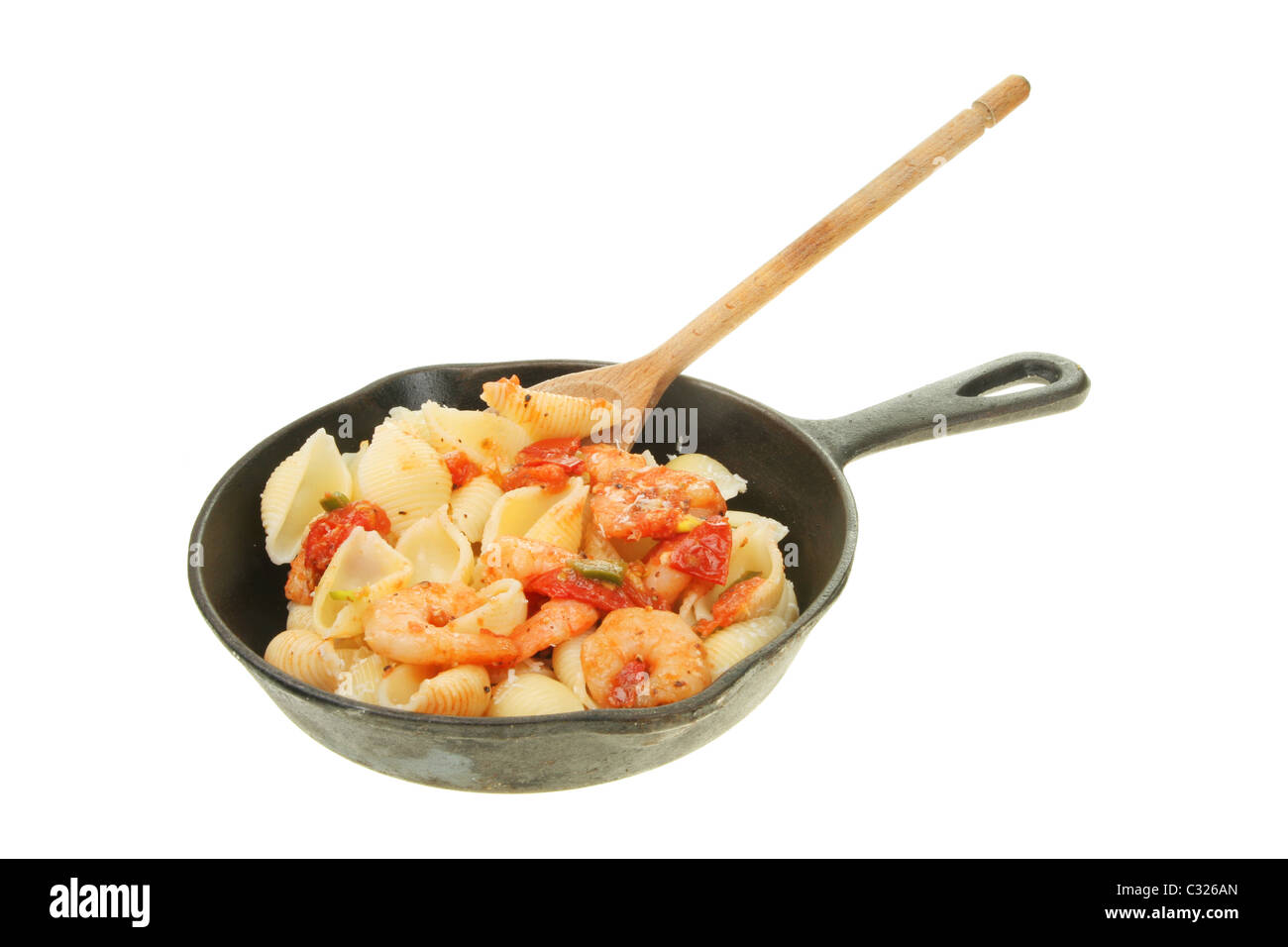 Prawns and conchiglie pasta in a cast iron frying pan Stock Photo
