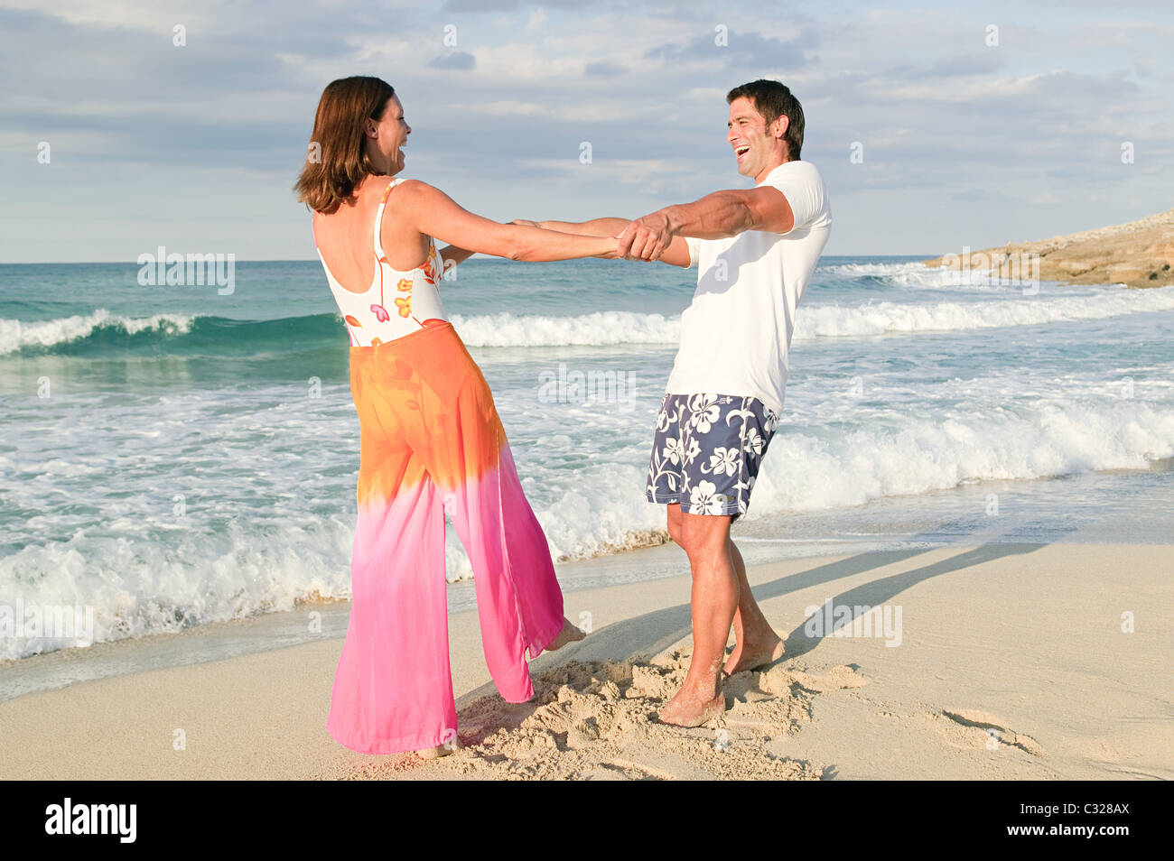 Couple having fun on a beach Stock Photo