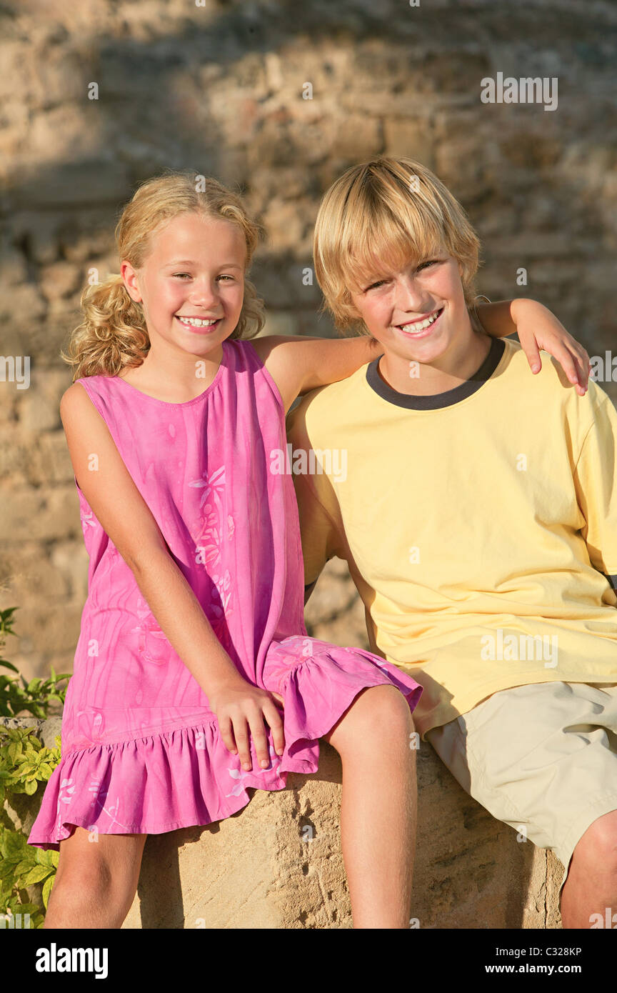 Happy brother and sister outdoors Stock Photo
