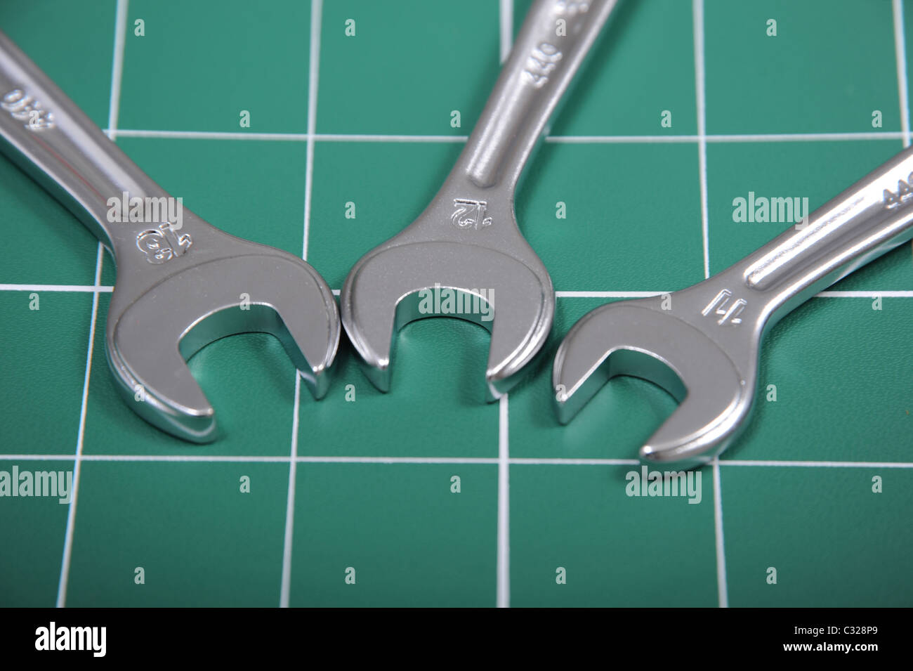 Spanners on a green cutting matt Stock Photo