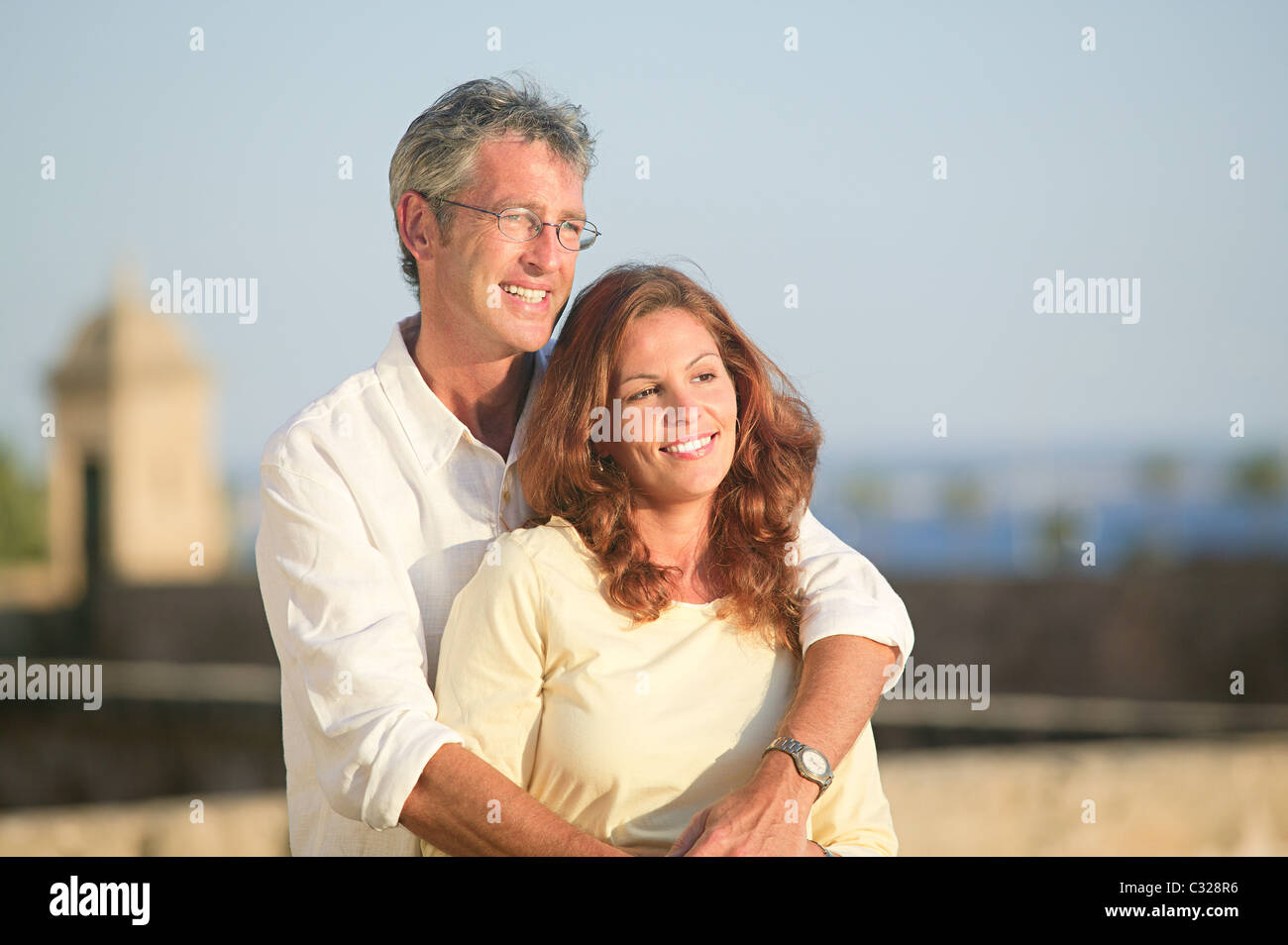 Mature couple outdoors, man with arms around woman Stock Photo