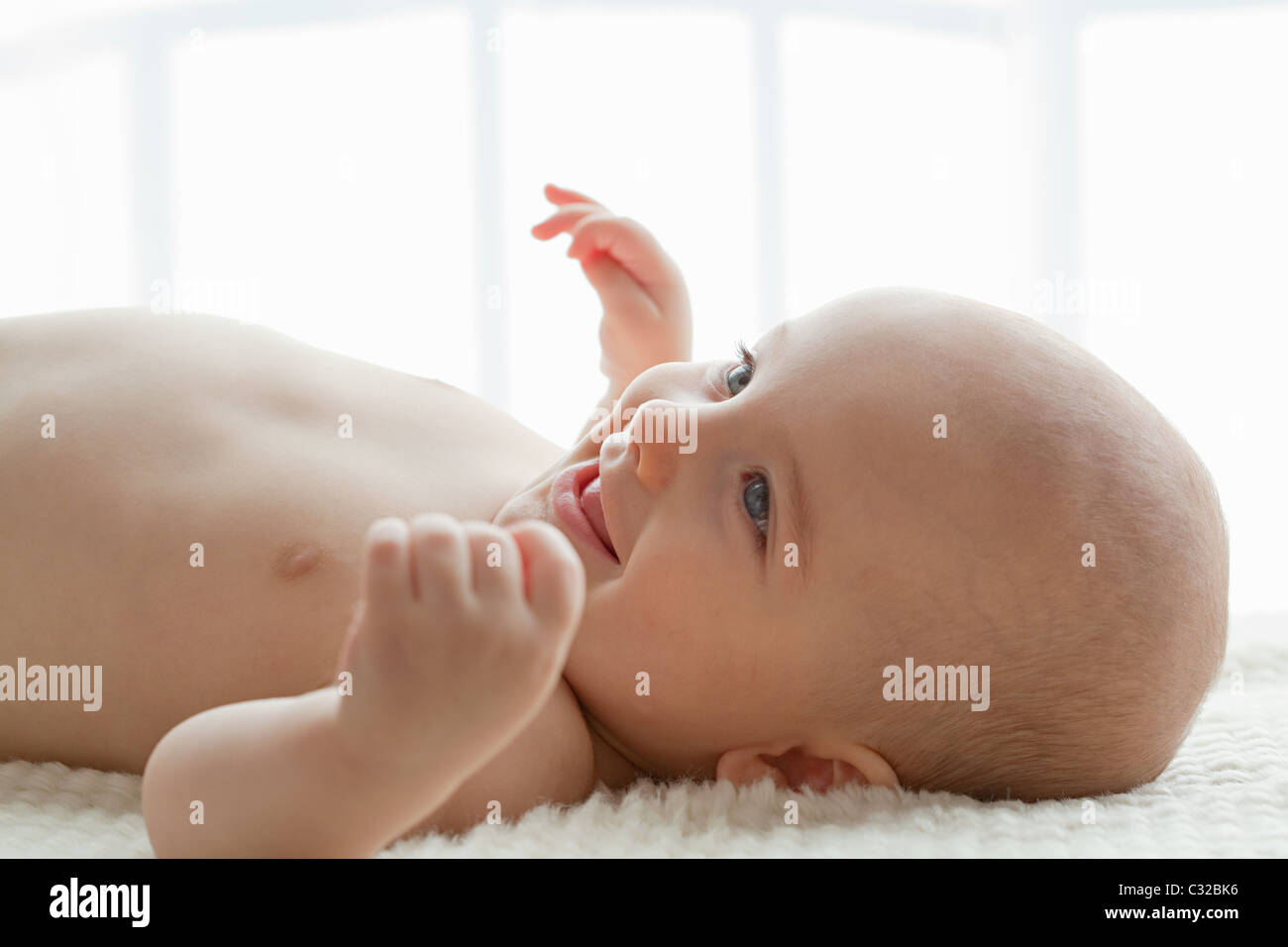 Baby boy lying on back Stock Photo