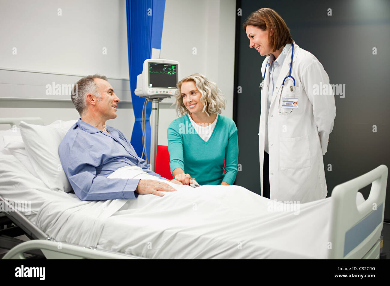 Wife Visiting Husband In Hospital Talking To Doctor Stock Photo Alamy