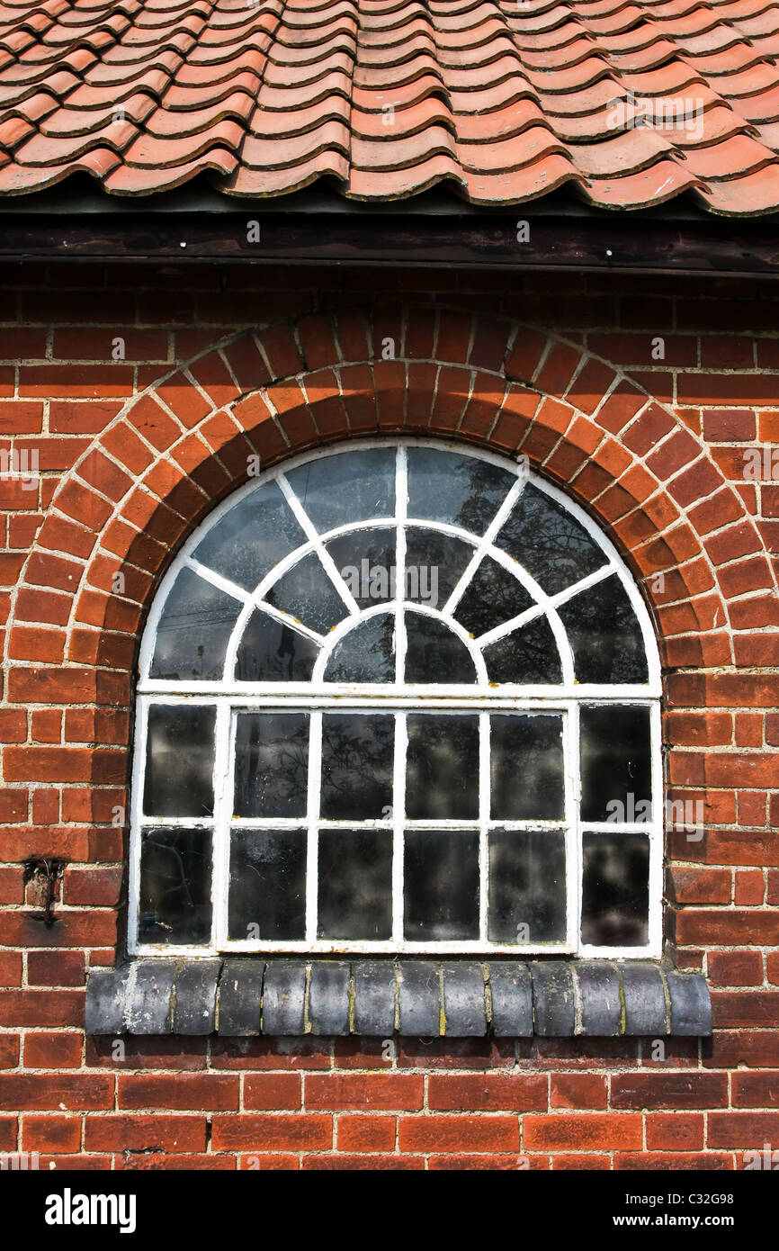 Old window in a red brick wall farm building Stock Photo - Alamy