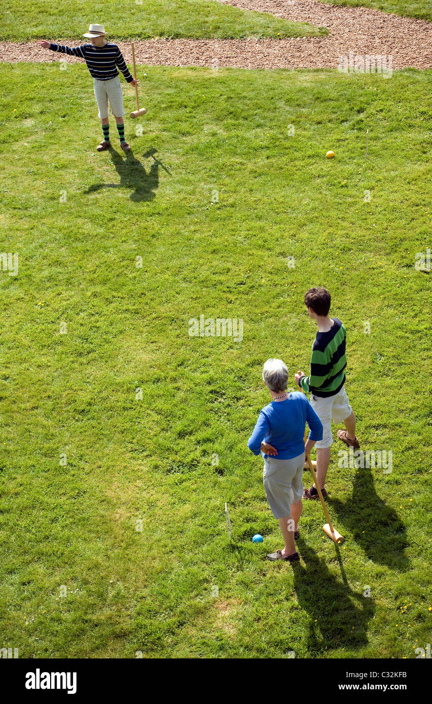 Family of English Croquet players with mallets, boy, men, man, grass