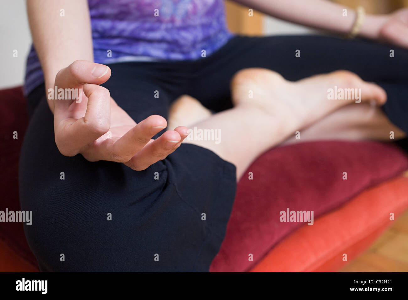 Women in lotus position during yoga Stock Photo