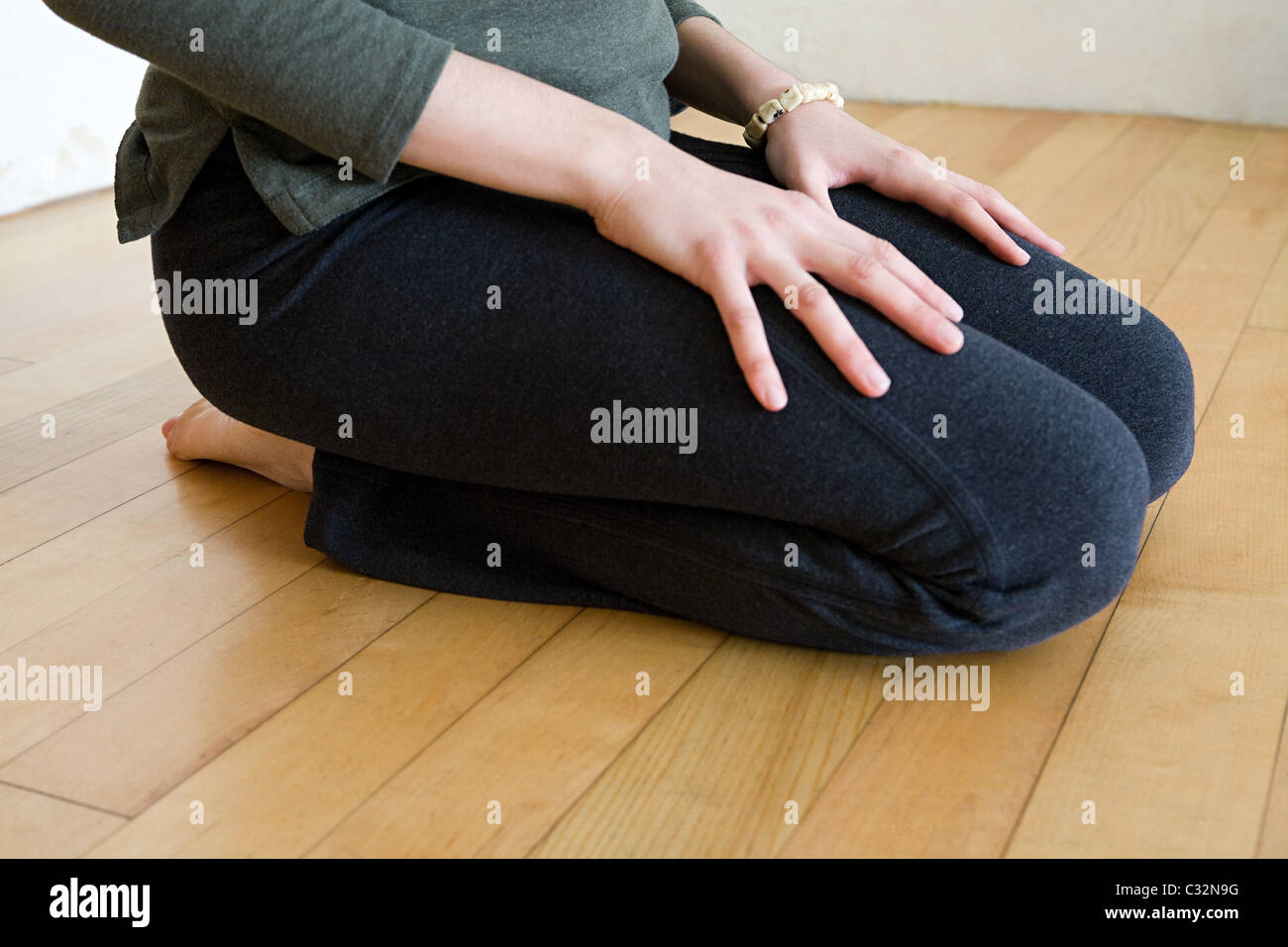 Woman kneeling Stock Photo