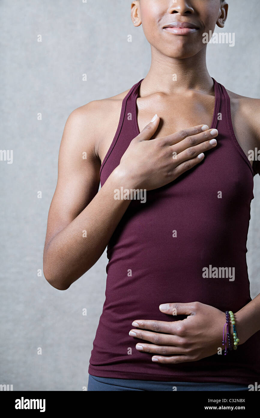 Women breathing deeply, touching chest and abdomen Stock Photo