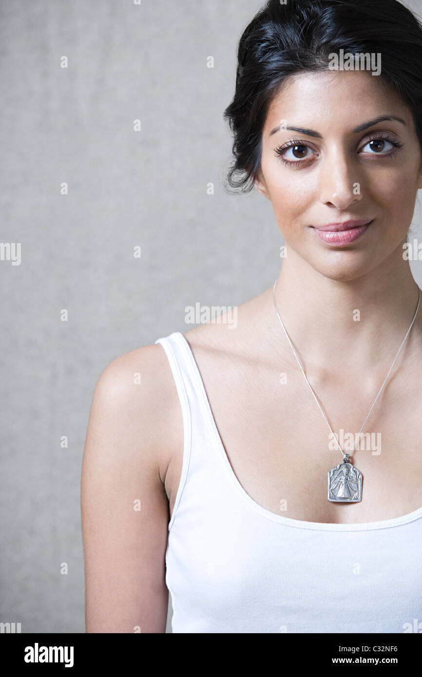 Woman wearing silver pendant looking at camera Stock Photo