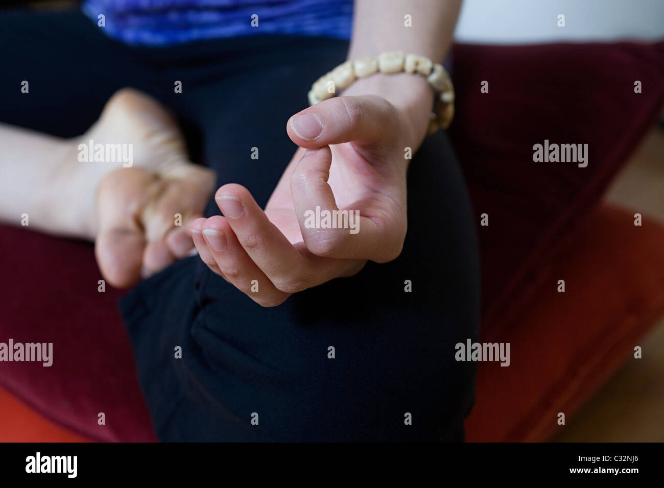 Women in lotus position during yoga Stock Photo