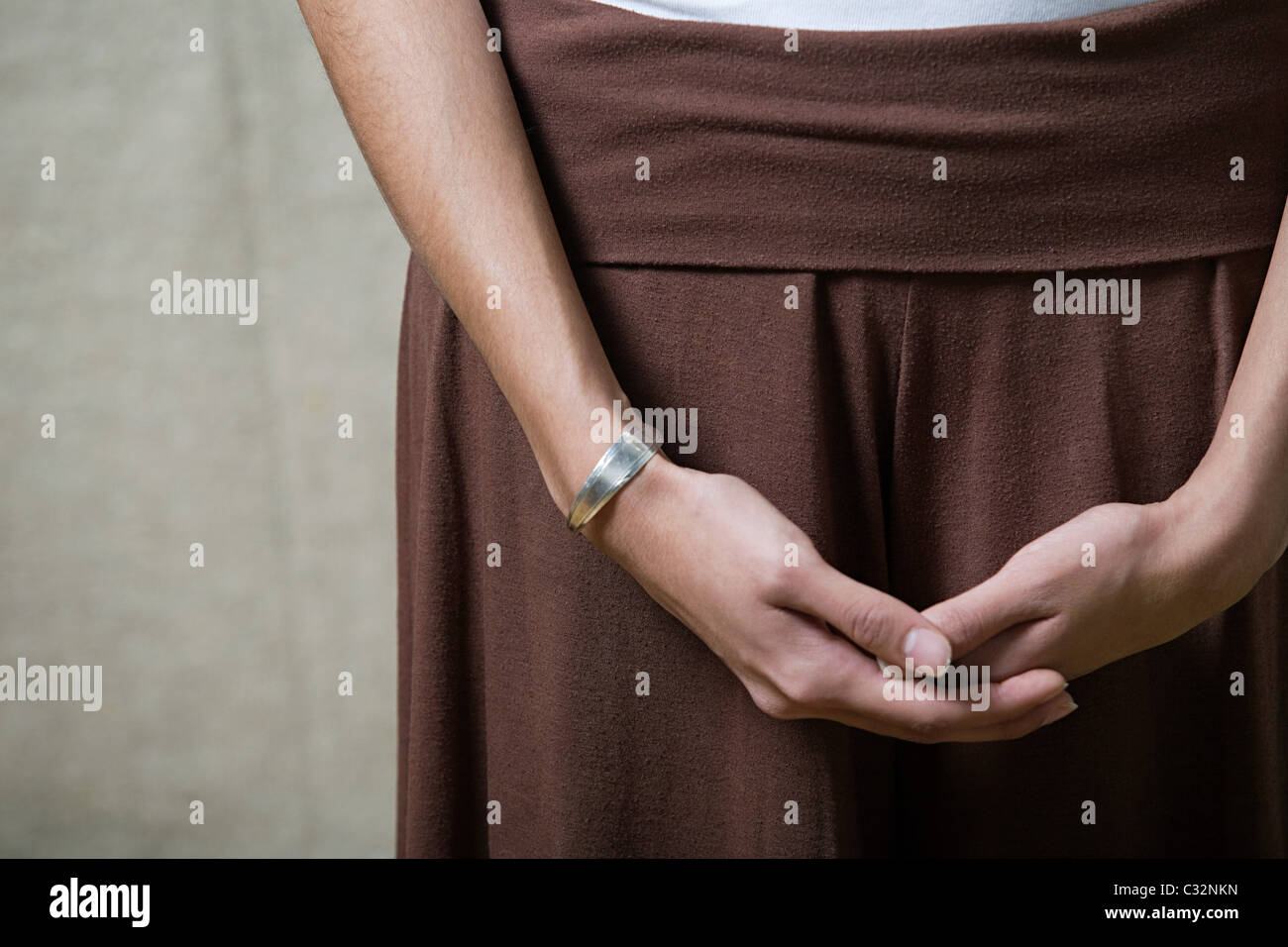 Woman with hands clasped, close up Stock Photo