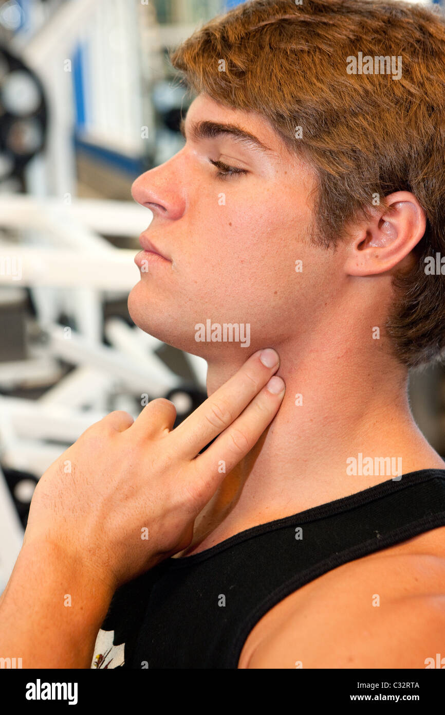 Young man checks heartbeat Stock Photo