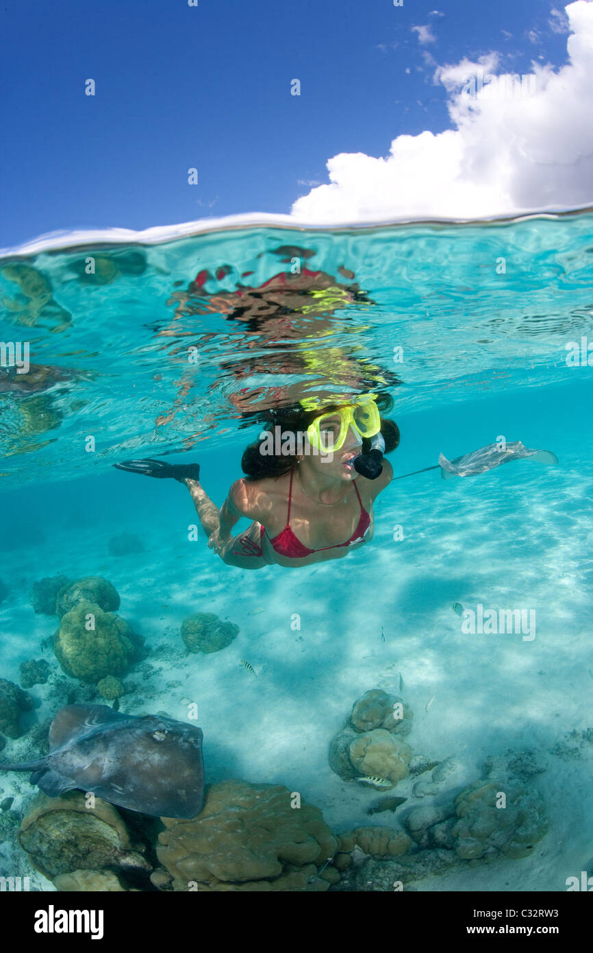 Over/under of snorkeler and ray Stock Photo