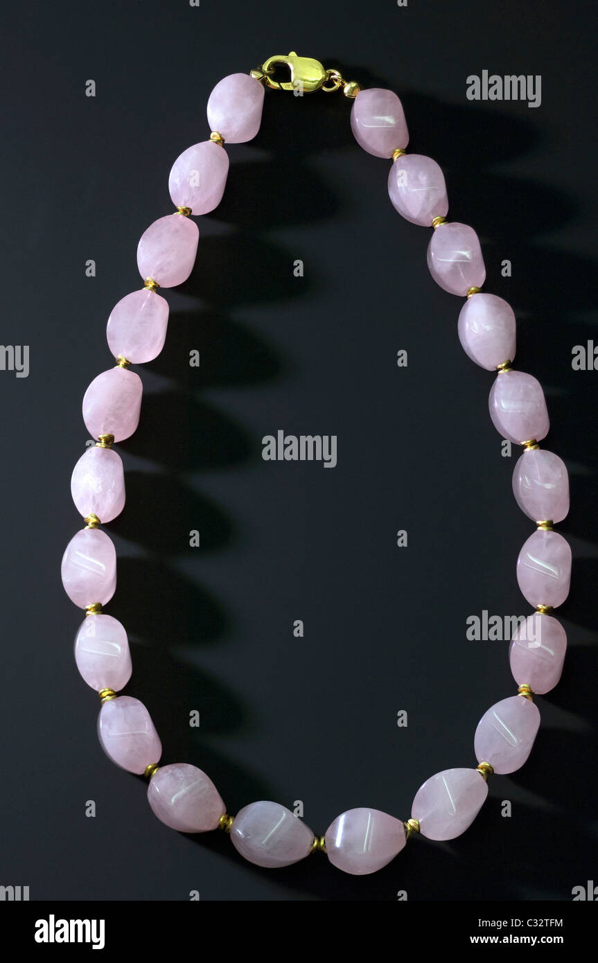 Necklace made of Rose Quartz, studio picture against a dark background. Stock Photo