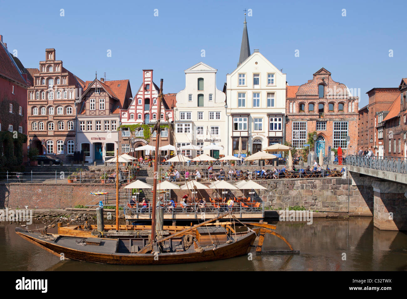 Am Stintmarkt, sculler and pram in the old harbour, Lueneburg, Lower Saxony, Germany Stock Photo