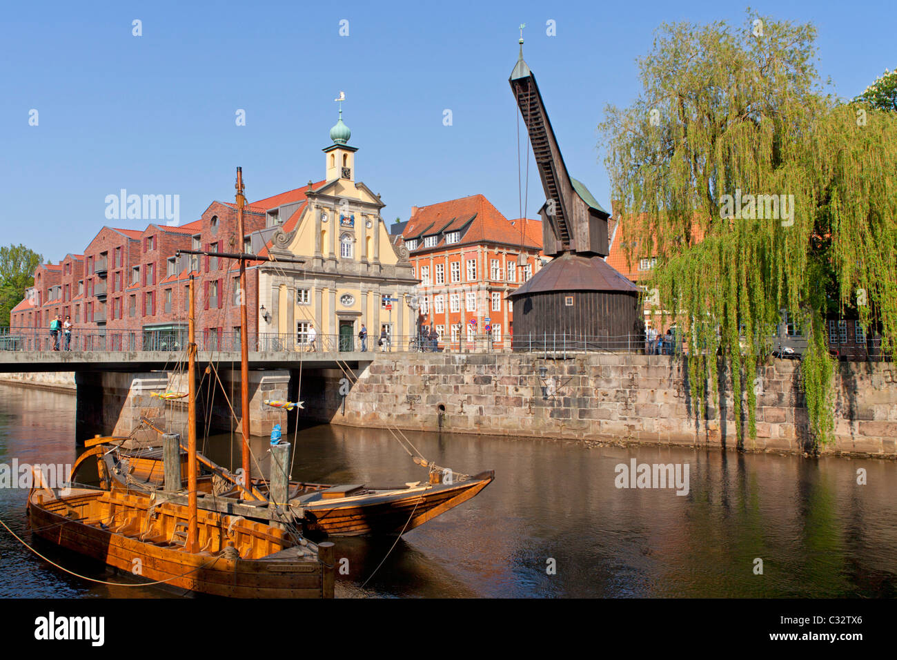 old crane, sculler and pram in the old harbour, Lueneburg, Lower Saxony, Germany Stock Photo