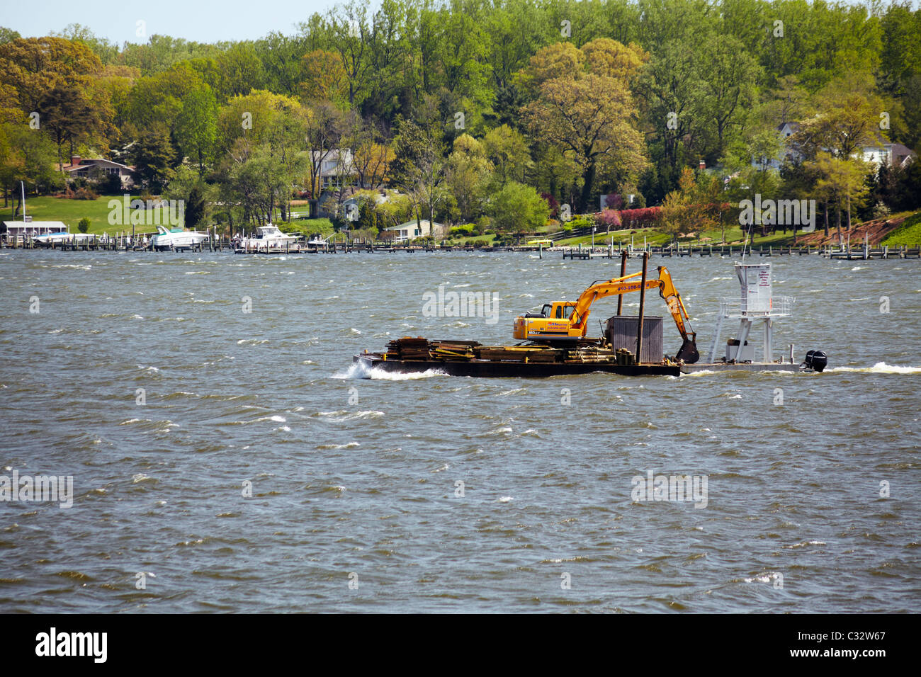 Marine construction equipment being transported on the South River, Edgewater, Maryland. Stock Photo