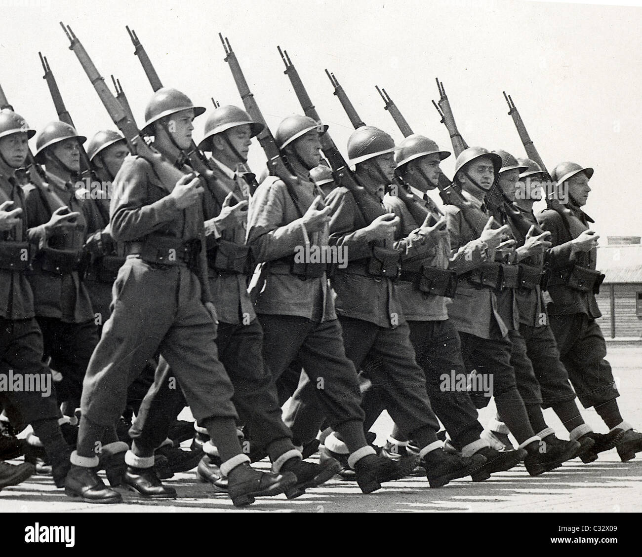 Free French troops march past in review with rifles and fixed bayonets. WW11 Stock Photo