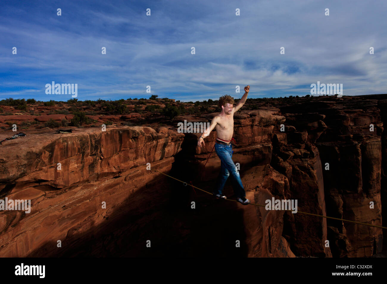 Andy Lewis walks across a highline in a swammy belt at the Fruit Bowl