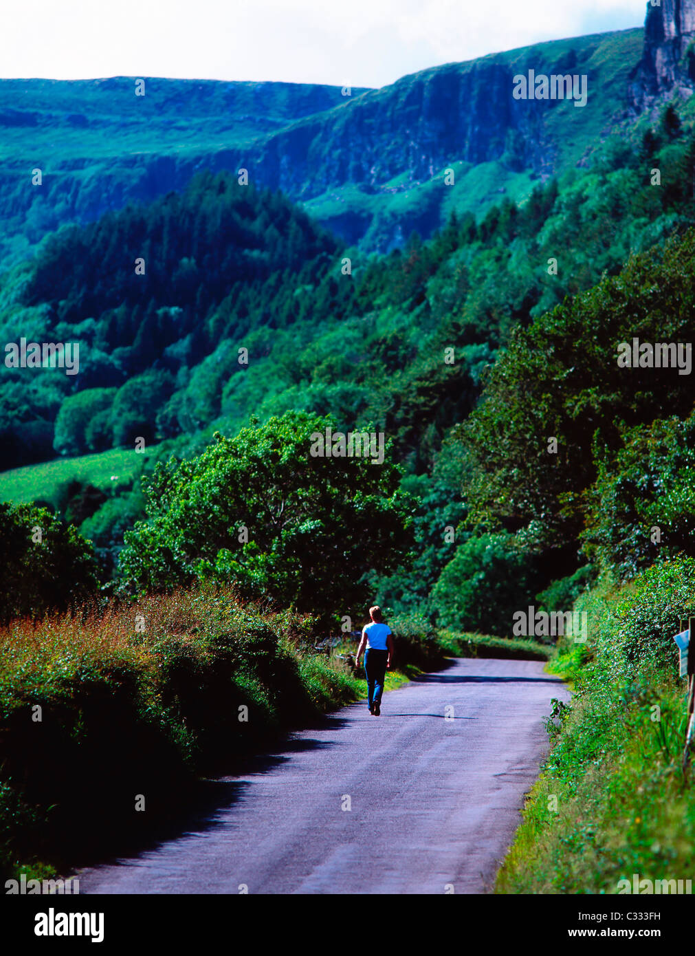 Rear View Of A Person Walking On Road Stock Photo