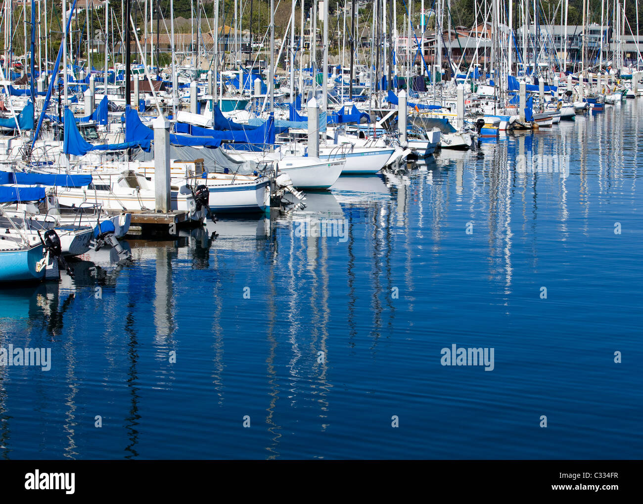Small sail boats docked in marina slips Stock Photo