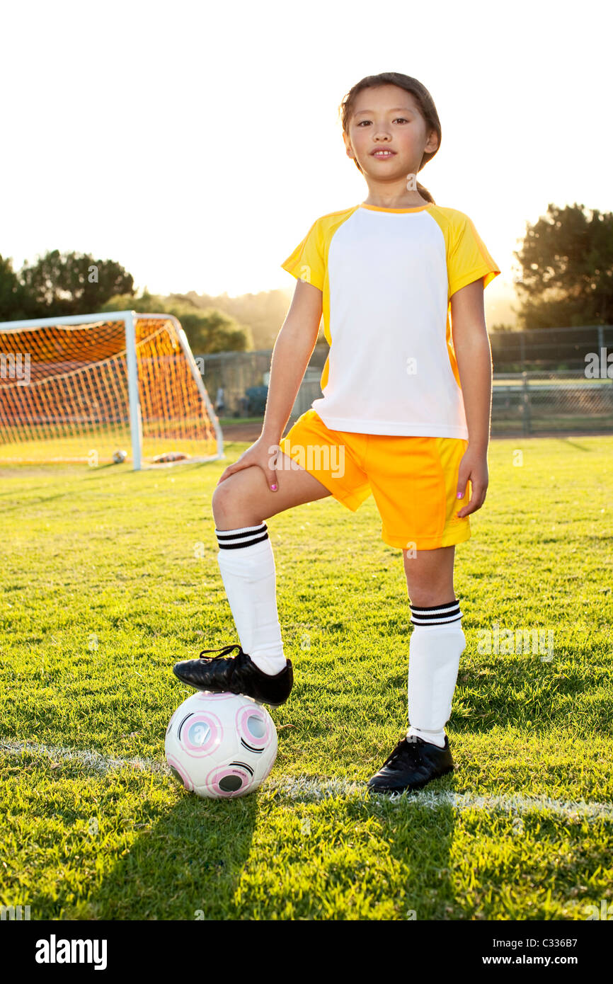 A young girl posing with her soccer ball on a soccer field in Los Angeles, California. Stock Photo