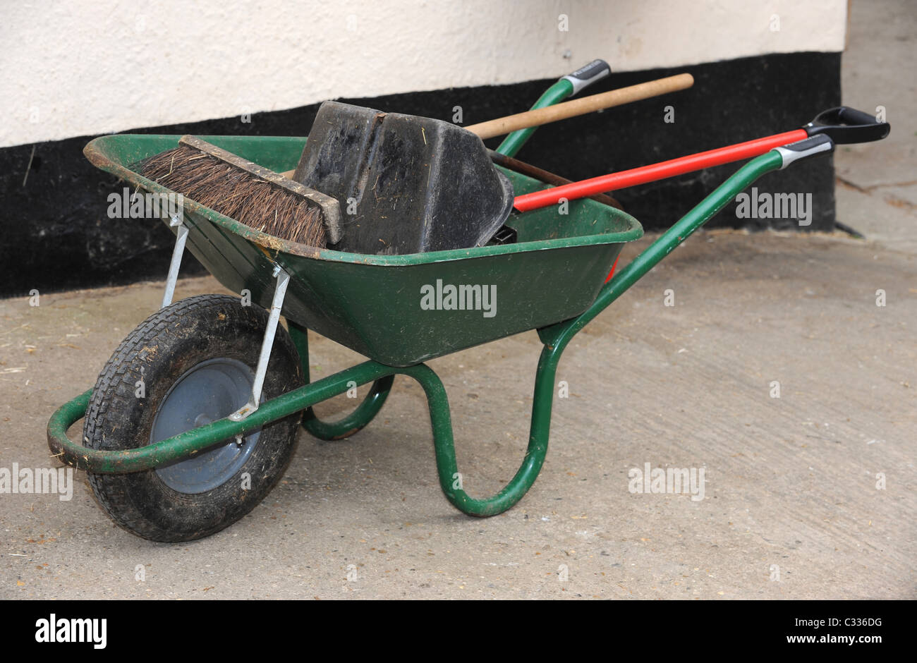 A Wheelbarrow and tools on a Stable Yard Stock Photo Alamy