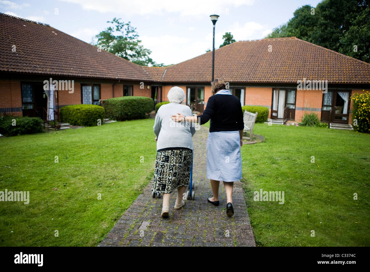 Resident with carer at old people's home Stock Photo