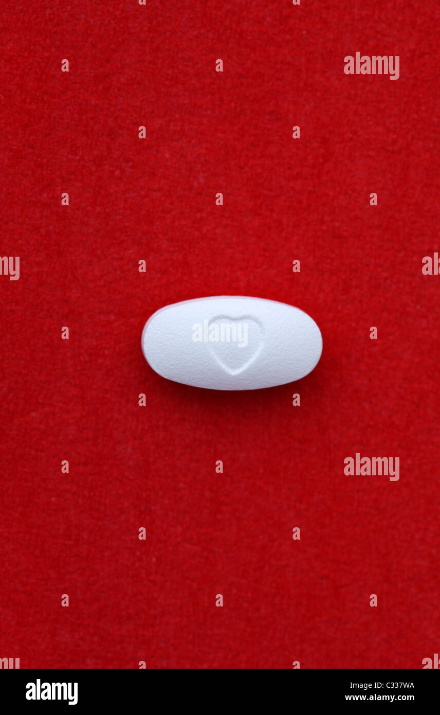 Pill with a heart shaped on it. Stock Photo