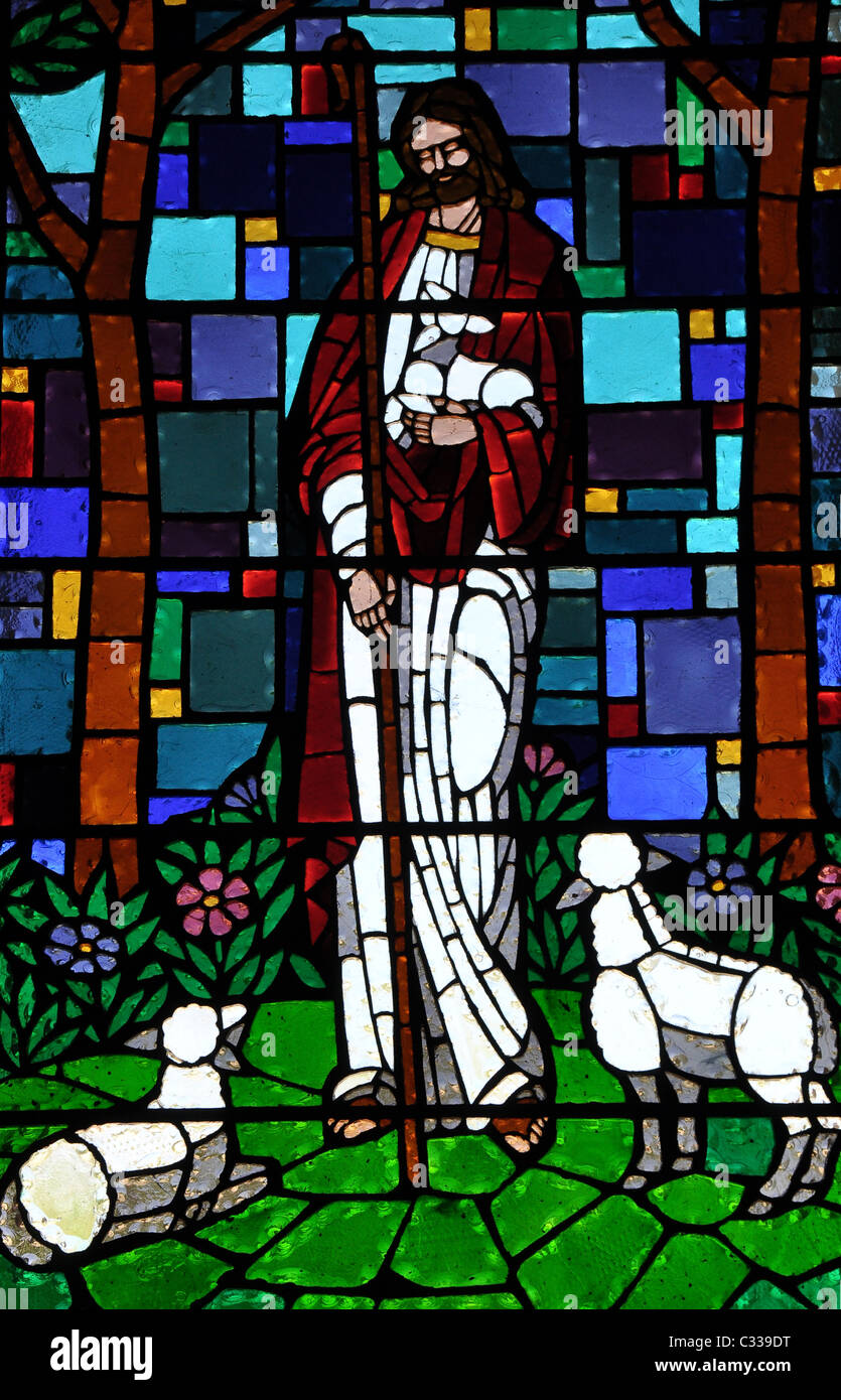 A stainglass window of Jesus Christ holding a lamb Stock Photo