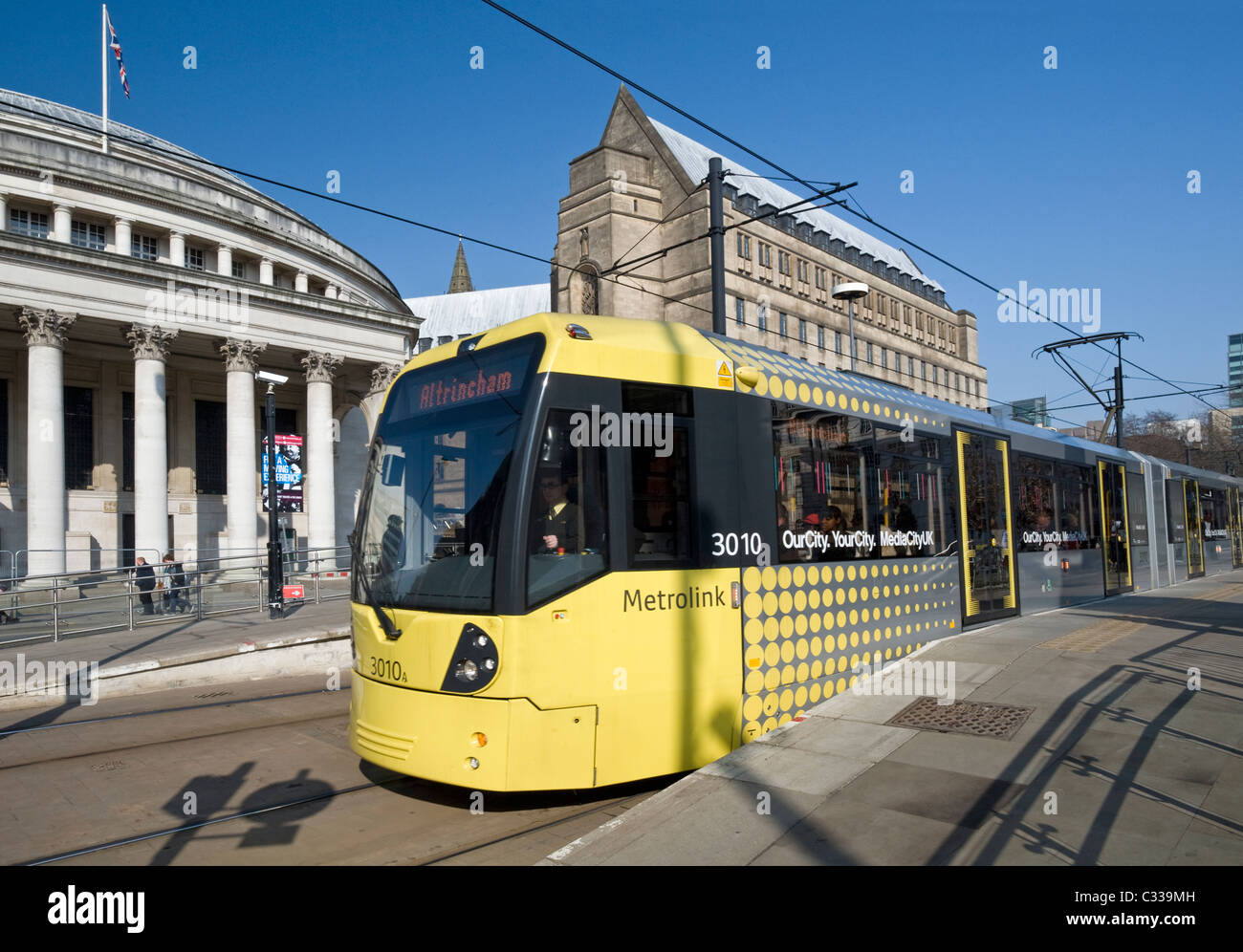Manchester Metrolink Tram at Platform in front of the Manchester Central Library, Greater Manchester, England, UK Stock Photo