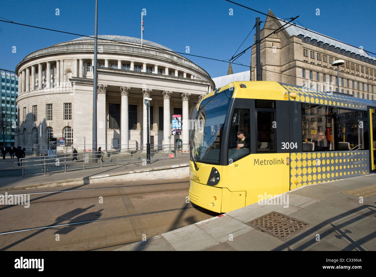 Manchester Metrolink Tram at Platform in front of the Manchester Central Library, Greater Manchester, England, UK Stock Photo