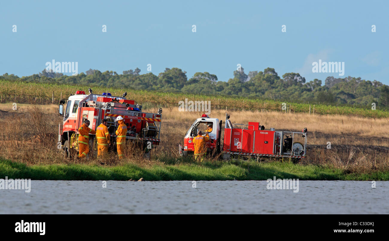 Volunteer Firefighters at their fire trucks after attending a grass fire. Pokolbin, Hunter Valley, NSW, Australia. Stock Photo