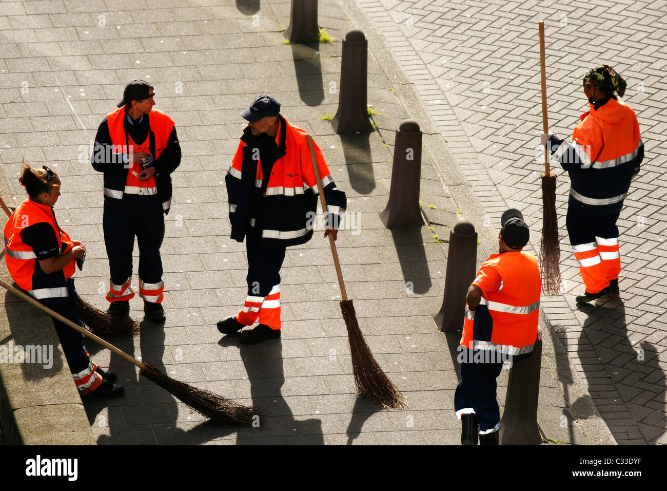 Group crowd street cleaners hi vis jacket talking not working at street of Rotterdam, Netherlands Stock Photo