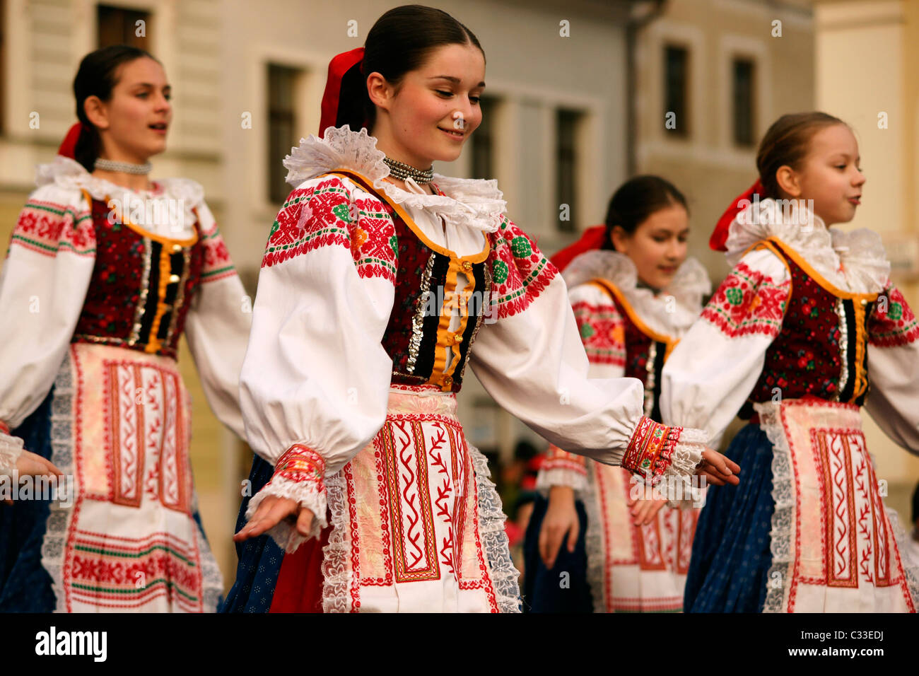 Girl folklore group dancing performing and singing outdoors traditional